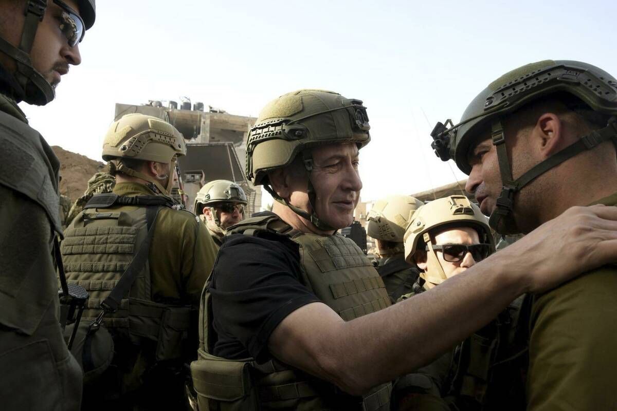 Israel's Prime Minister Benjamin Netanyahu, centre, greets soldiers as he visits the Gaza Strip ...