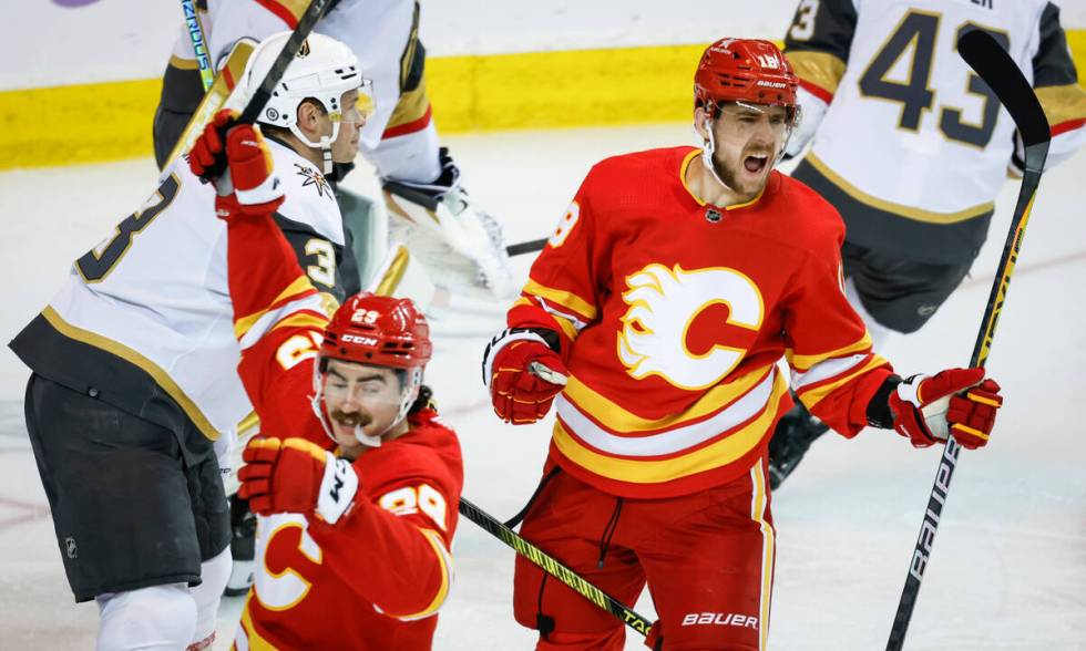 Vegas Golden Knights defenseman Brayden McNabb, left, looks on as Calgary Flames forward A.J. G ...