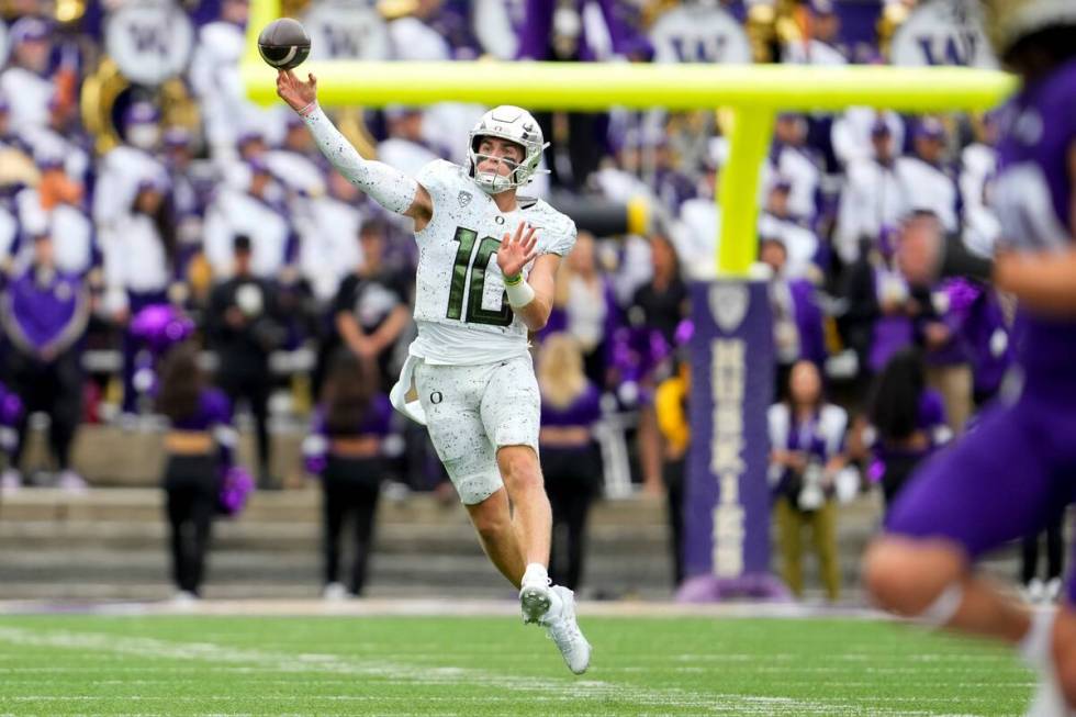 Oregon quarterback Bo Nix looks throws against Washington during the first half of an NCAA coll ...