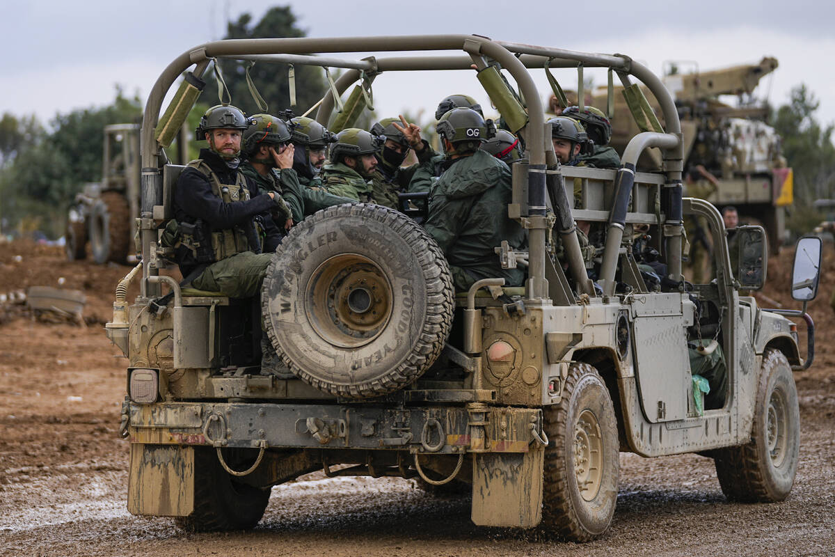 Israeli soldiers move near the border with the Gaza Strip, southern Israel, Monday, Nov. 27, 20 ...