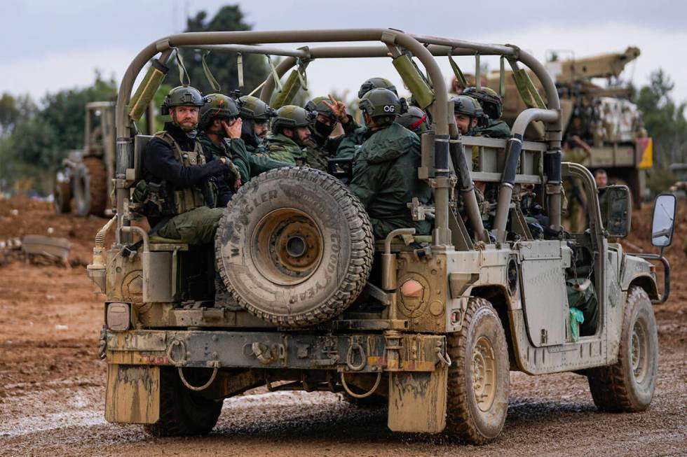 Israeli soldiers move near the border with the Gaza Strip, southern Israel, Monday, Nov. 27, 20 ...