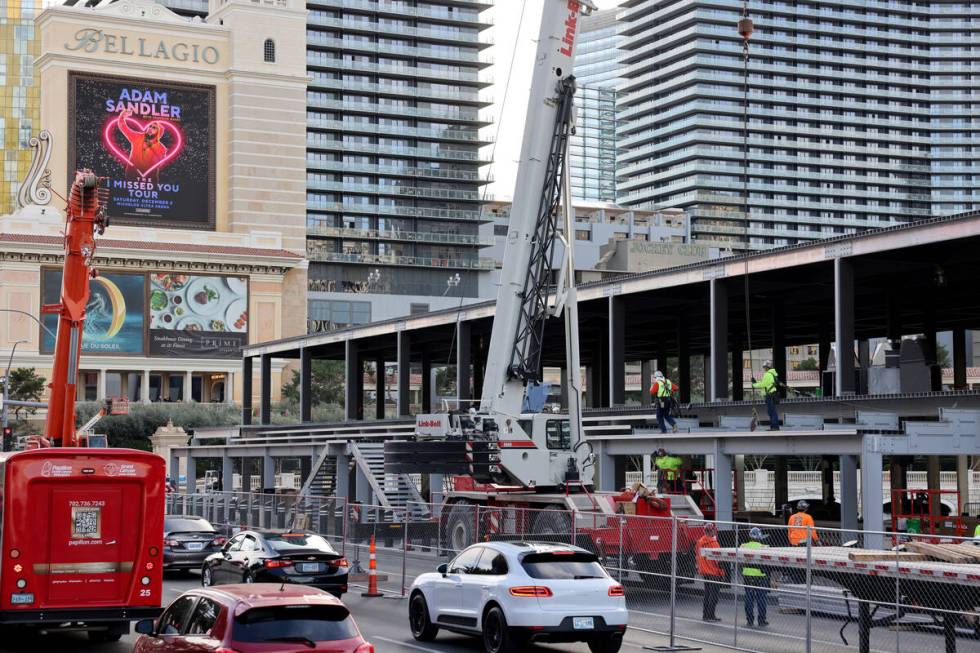 Workers dismantle Formula One grandstands and luxury boxes at the Bellagio fountains on the Str ...