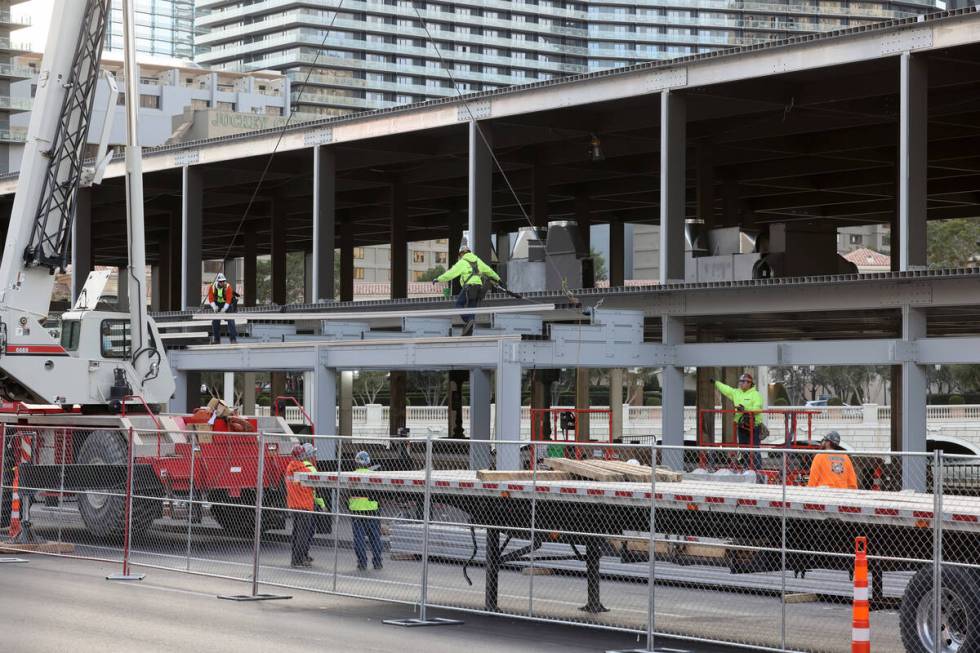 Workers dismantle Formula One grandstands and luxury boxes at the Bellagio fountains on the Str ...