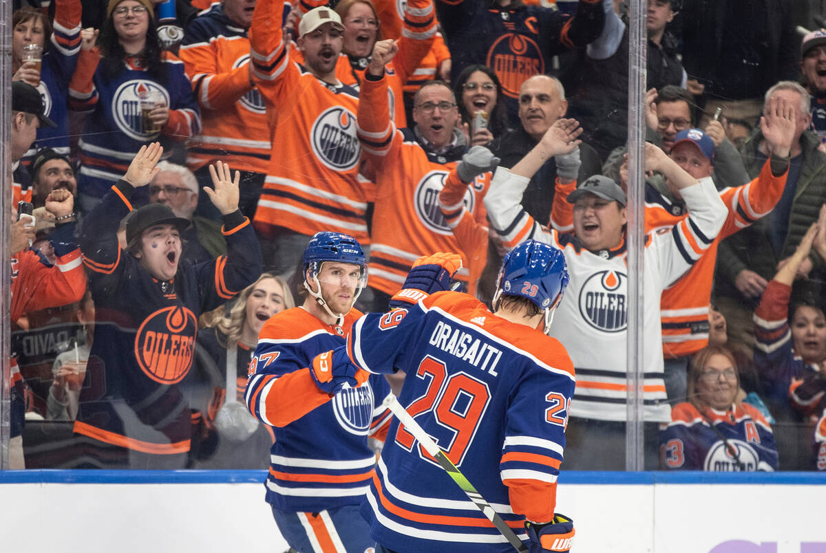 Edmonton Oilers' Connor McDavid (97) and Leon Draisaitl (29) celebrate a goal against the Vegas ...