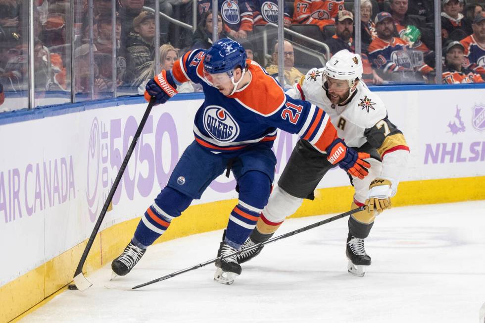 Vegas Golden Knights' Alex Pietrangelo (7) and Edmonton Oilers' Adam Erne (21) battle for the p ...