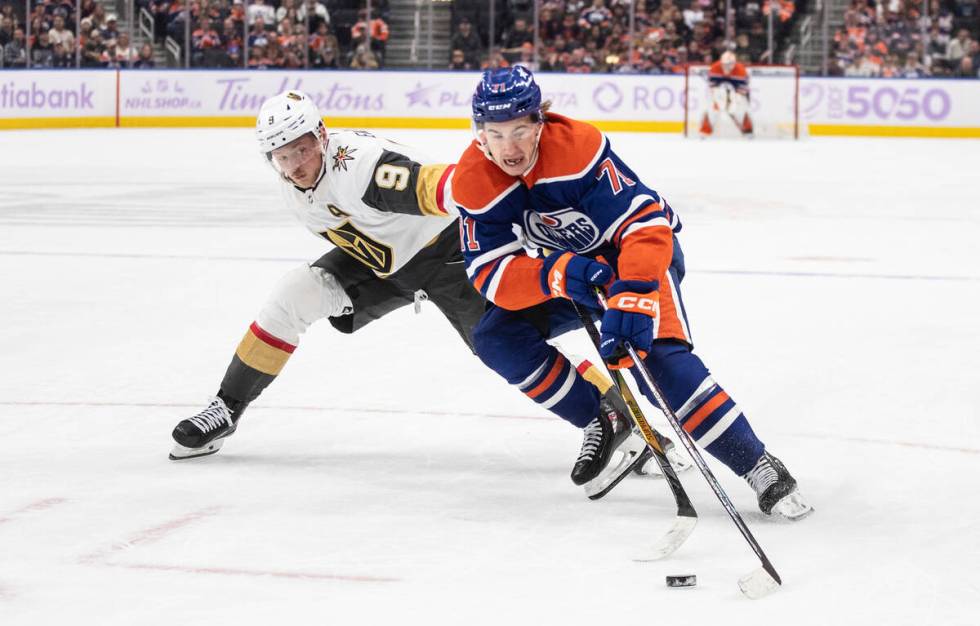 Vegas Golden Knights' Jack Eichel (9) and Edmonton Oilers' Ryan McLeod (71) battle for the puck ...