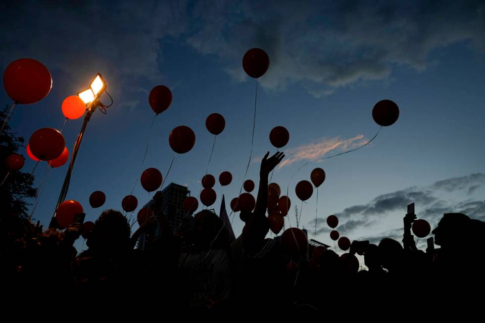 Protesters release balloons as they call for the release of the Bibas family, whose members are ...