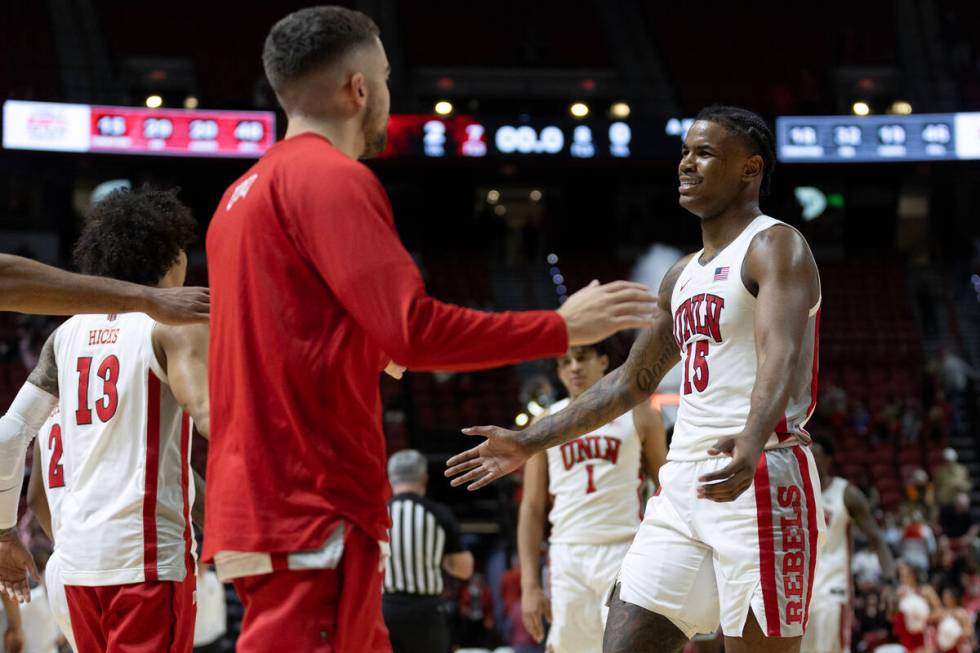 UNLV Rebels guard Luis Rodriguez (15) celebrates with his team after winning an NCAA college ba ...