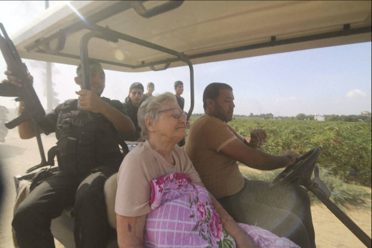 FILE - In this still image taken from video, Hamas' militants transport Yaffa Adar, 85, an Isra ...