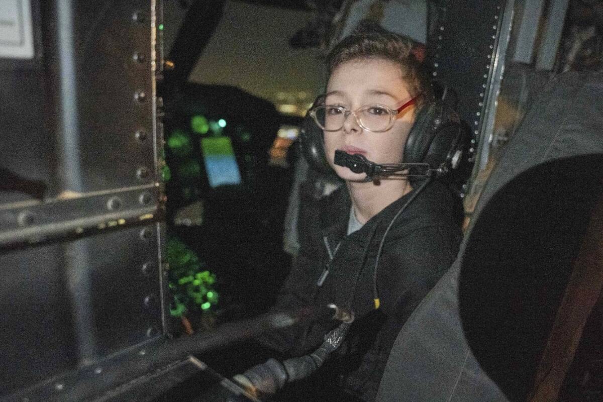 Released Israeli hostage Ohad Munder (9) sits inside an Israeli military helicopter, shortly af ...