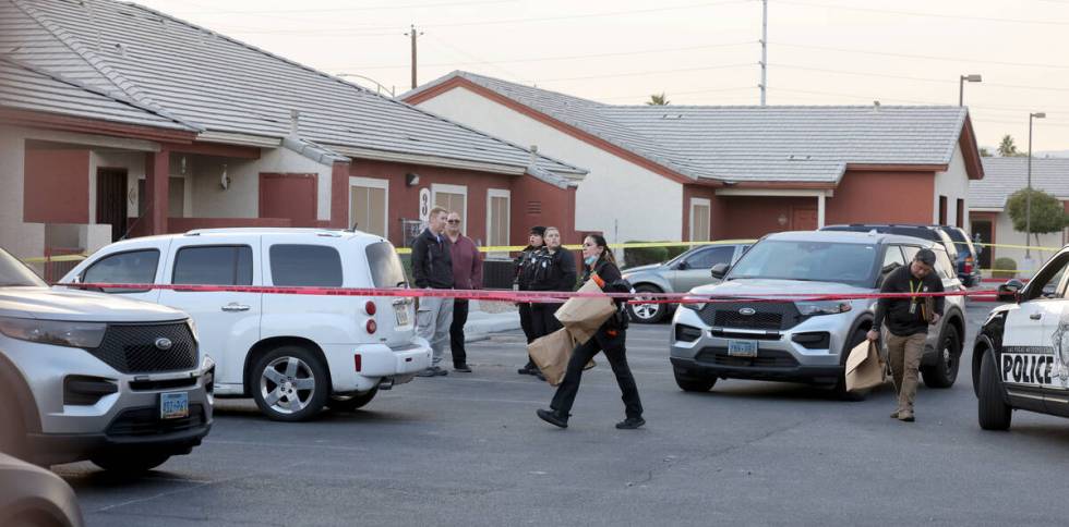 Las Vegas police investigate a white Chevrolet HHR in a housing complex on Monroe Avenue near I ...