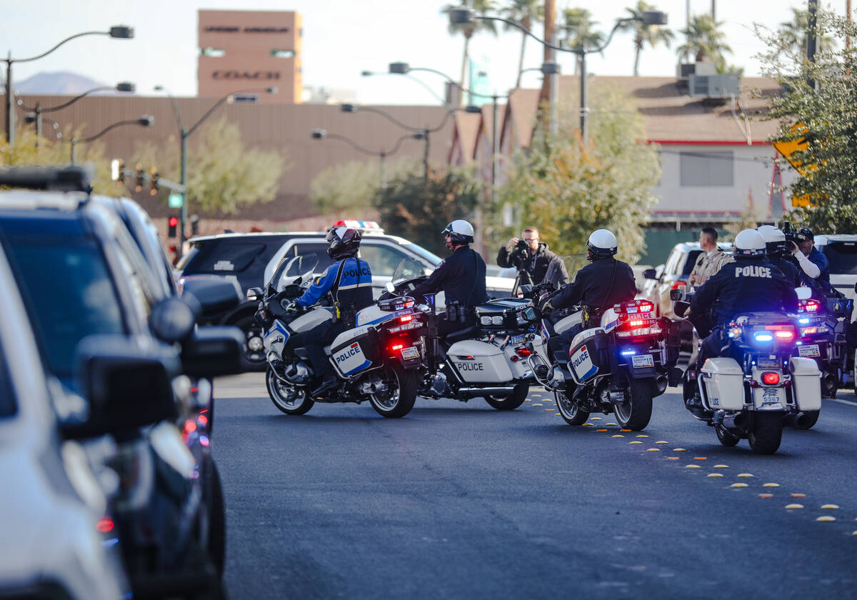 A police procession for a slain Nevada Highway Patrol trooper moves toward the coroner’s offi ...