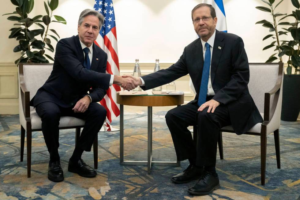 Israeli President Isaac Herzog, right, and US Secretary of State Antony Blinken shake hands dur ...