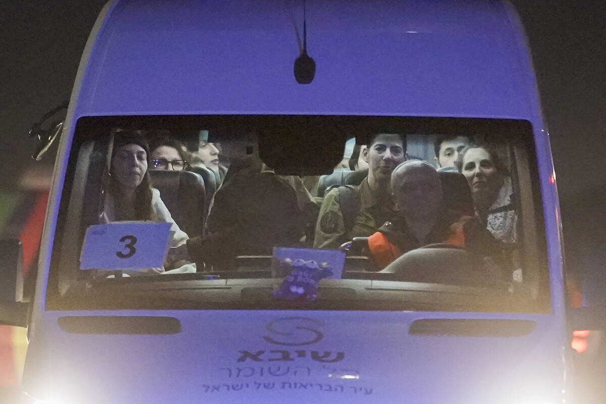 A mini-bus carrying Israeli hostages released by Hamas and Israeli military personnel arrives a ...