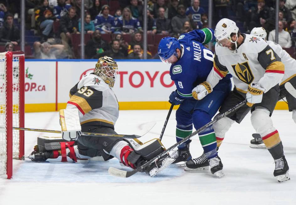 Vegas Golden Knights goalie Adin Hill (33) stops Vancouver Canucks' J.T. Miller (9) as Golden K ...