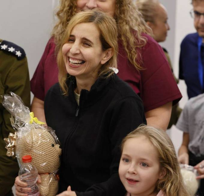 Danielle Aloni laughs next to her daughter Emilia Aloni as they meet family members at the Schn ...