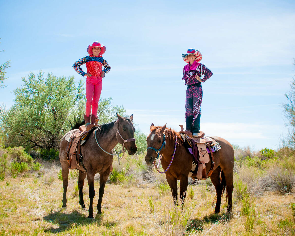 Rhea, left, and Rori Fenner pose on their horses and show off their matching all-around saddles ...