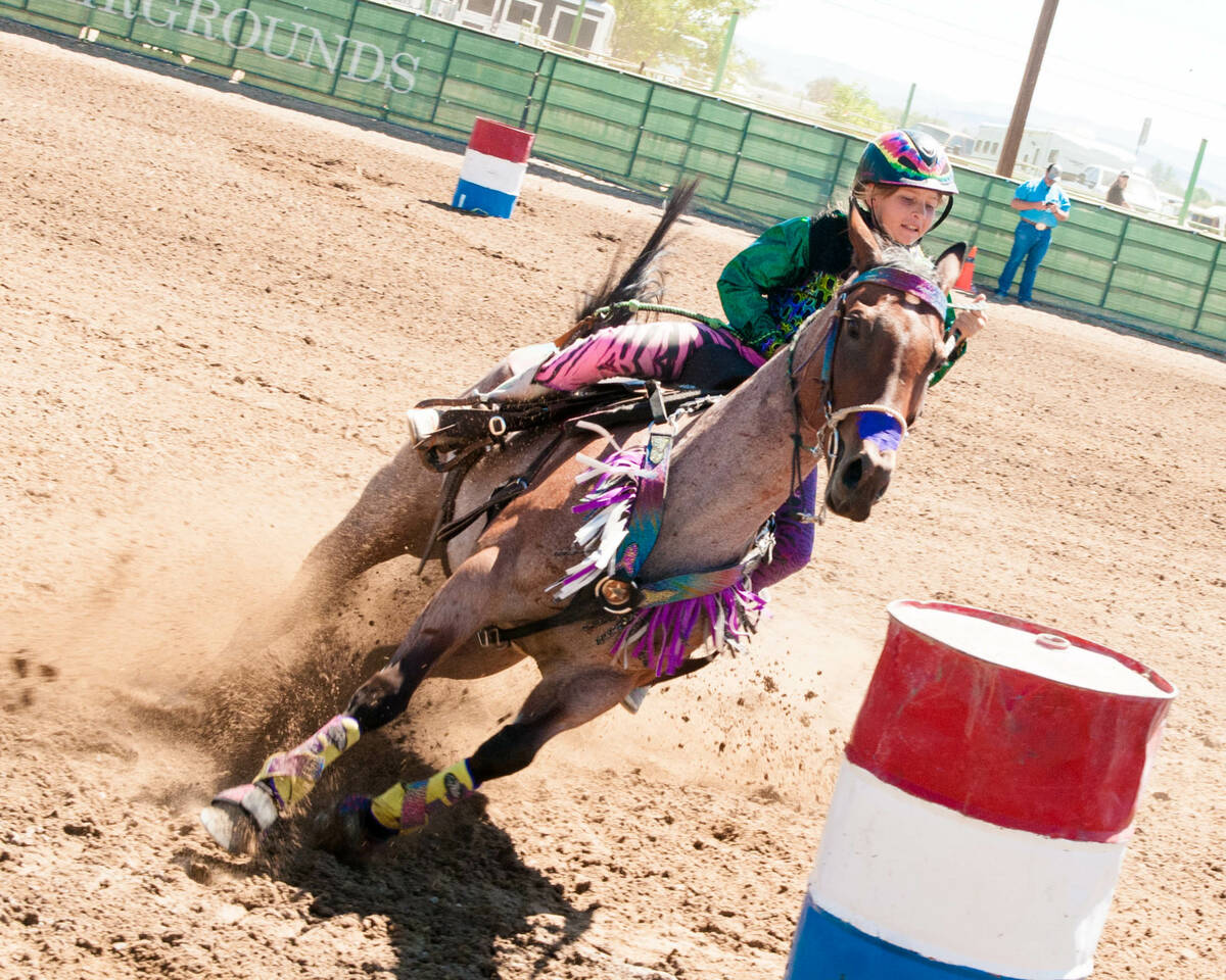 Rori Fenner rides into her first barrel on Matts Fancy Playgirl "Pink" at a Fallon, Nevada Barr ...