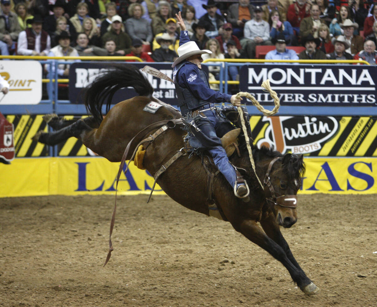 Professional bronc rider Billy Etbauer of Edmond, Okla. rides War Chick to a score of 88.5 to w ...