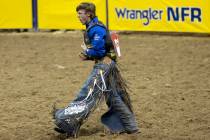 Stetson Wright, of Milford, Utah, celebrates after competing in bull riding during the eighth g ...