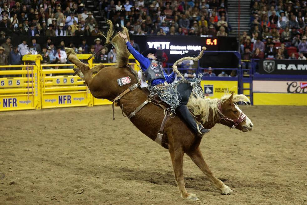 Stetson Wright of Milford, Utah, competes in the saddle bronc riding event during the ninth go- ...