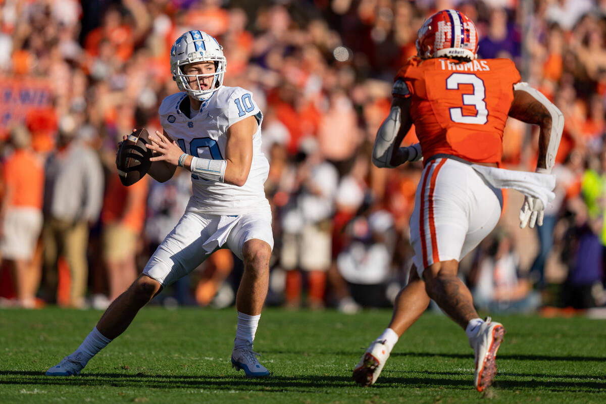 Clemson defensive end Xavier Thomas (3) pressures North Carolina quarterback Drake Maye (10) du ...