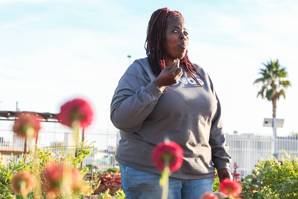 Tameka Henry, executive director of the Obodo Collective, tries a cherry tomato grown at the Ob ...
