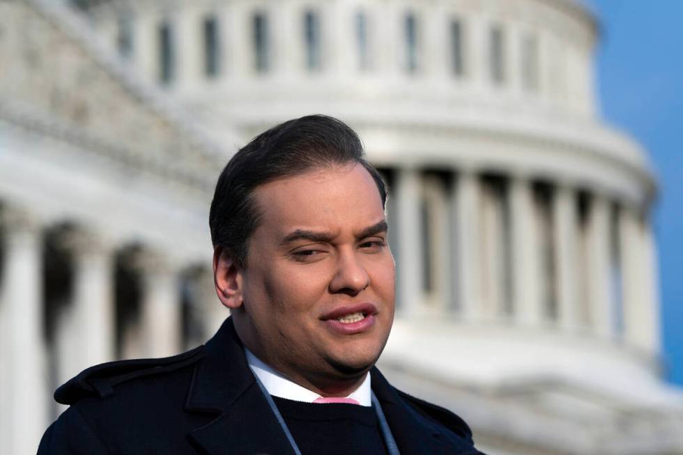 Rep. George Santos, R-N.Y., faces reporters at the Capitol in Washington, early Thursday, Nov. ...