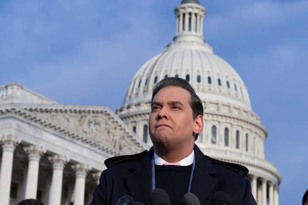 Rep. George Santos, R-N.Y., faces reporters at the Capitol in Washington, early Thursday, Nov. ...