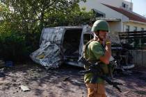 Israeli security personal inspect a site hit by a rocket fired from the Gaza Strip, In a commun ...