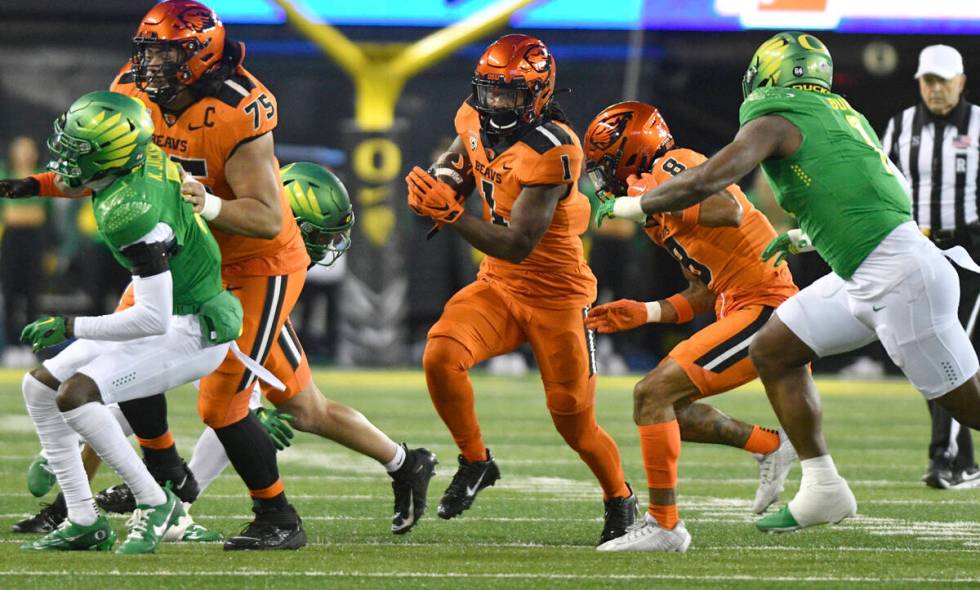 Oregon State running back Deshaun Fenwick rushes against Oregon during the first half of an NCA ...