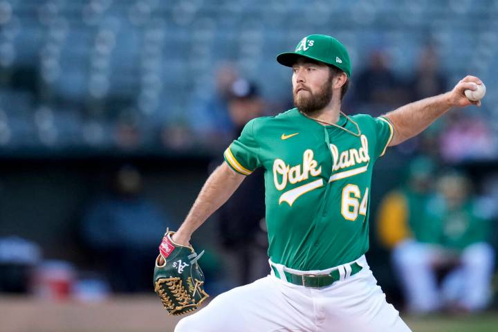 Oakland Athletics pitcher Ken Waldichuk throws against the Chicago Cubs during the first inning ...