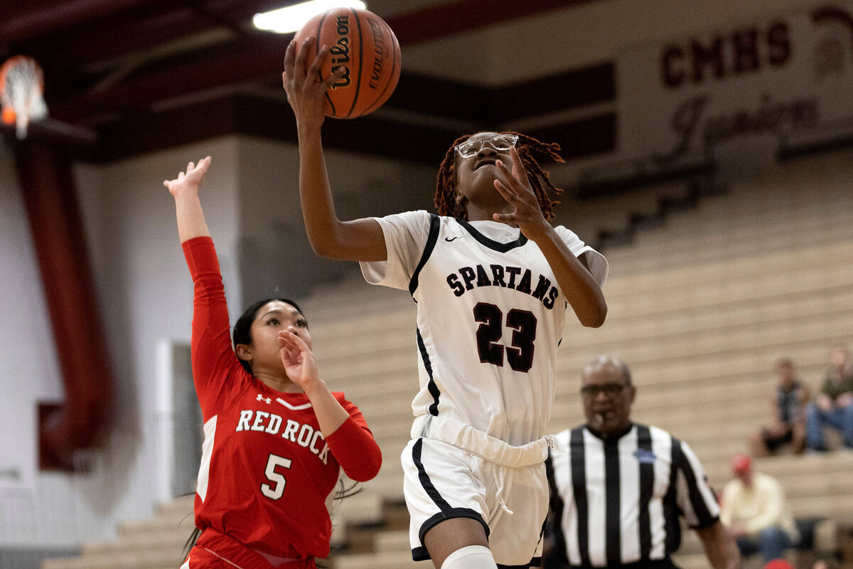 Cimarron-Memorial’s Dazani Graham (23) shoots against Doral’s Ryann Canda (5) dur ...