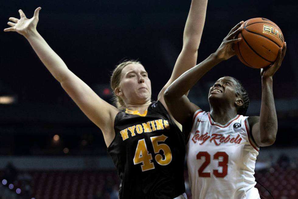 UNLV Lady Rebels center Desi-Rae Young (23) shoots against Wyoming Cowgirls center Allyson Fert ...