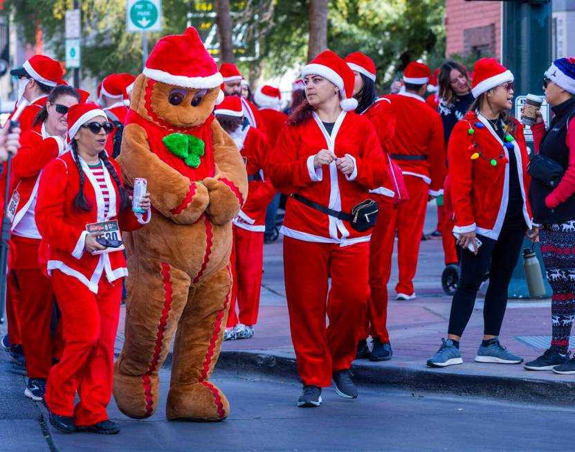 The Gingerbread Man and other participants walk to the starting line during the Las Vegas Great ...