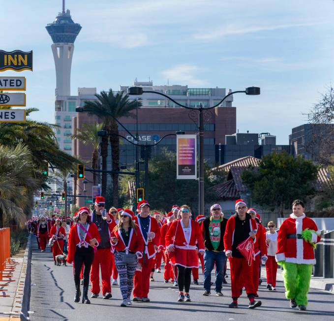 Participants in the 1-mile jaunt move up Las Vegas Boulevard heading to the finish line during ...