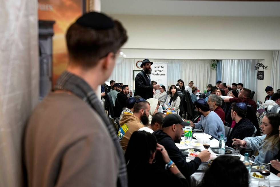 Cyprus' Chief Rabbi Arie Zeev Raskin, background, addresses young people who attended a retreat ...