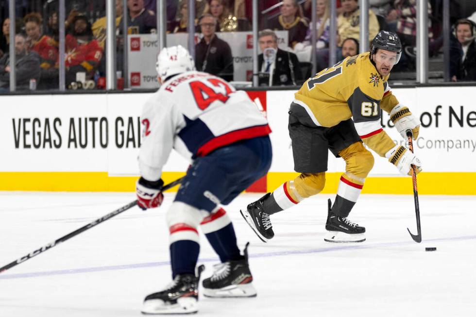 Golden Knights right wing Mark Stone (61) breaks away with the puck against Capitals defenseman ...