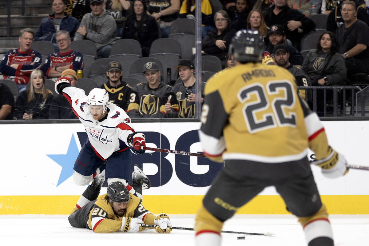 Golden Knights center Chandler Stephenson (20) dives for the puck to pass to Knights right wing ...