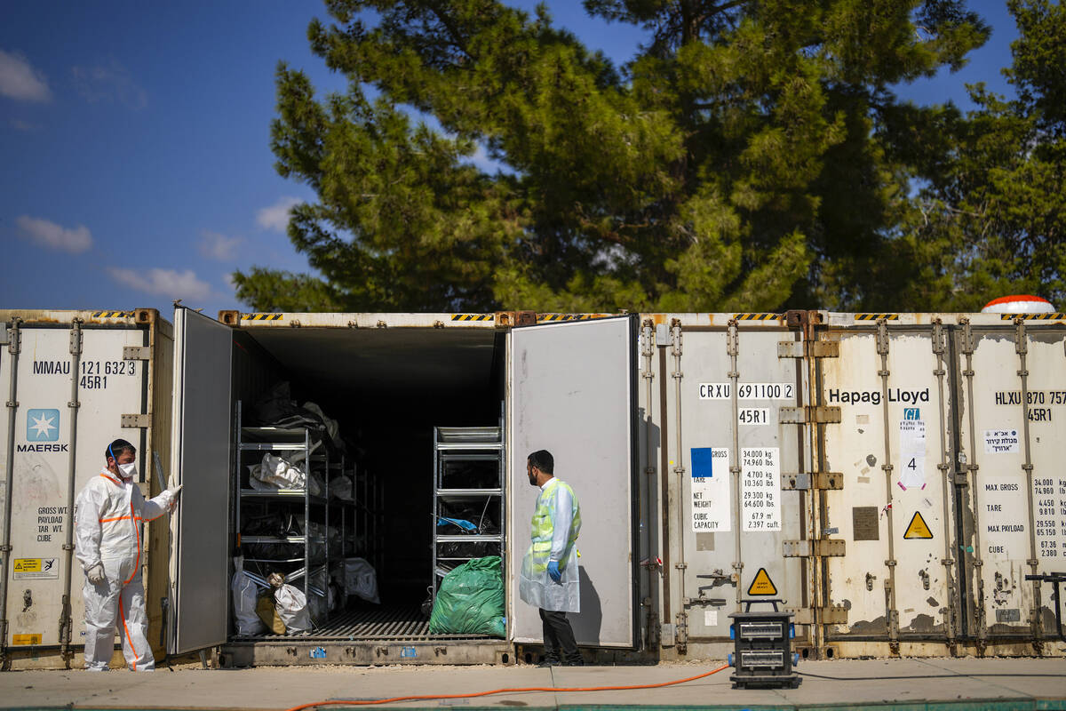 FILE - The bodies of Israelis killed in an unprecedented Hamas attack are gathered for identifi ...