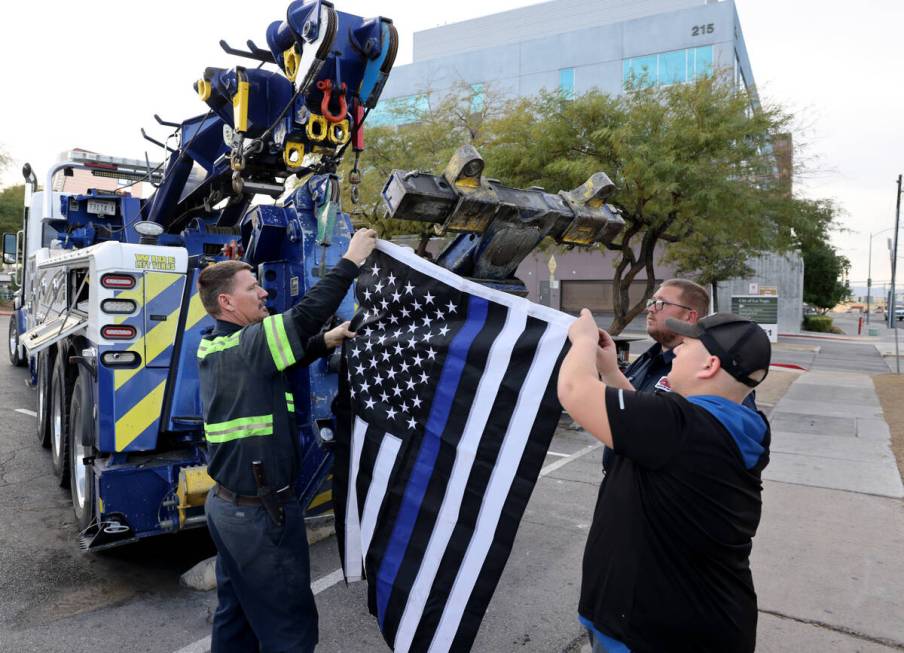 Tow truck operators, from left, Keith Grover, Derrick Svihl and James Svihl prepare at Dula Com ...