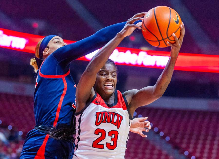 UNLV Lady Rebels center Desi-Rae Young (23) is fouled from behind by Arizona Wildcats forward I ...