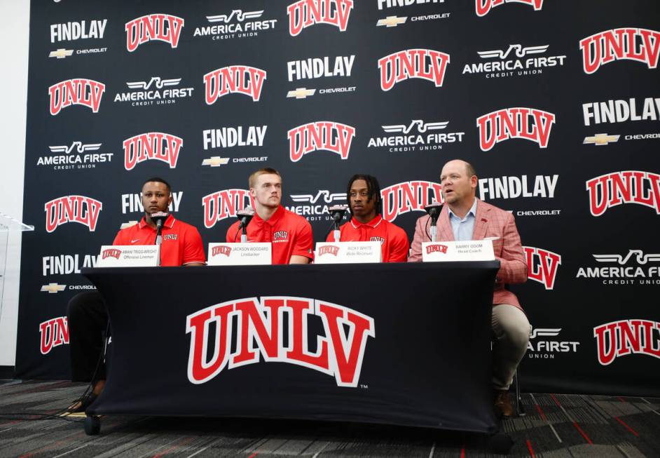 UNLV head coach Barry Odom, from right, addresses media next to wide receiver Ricky Wright, lin ...
