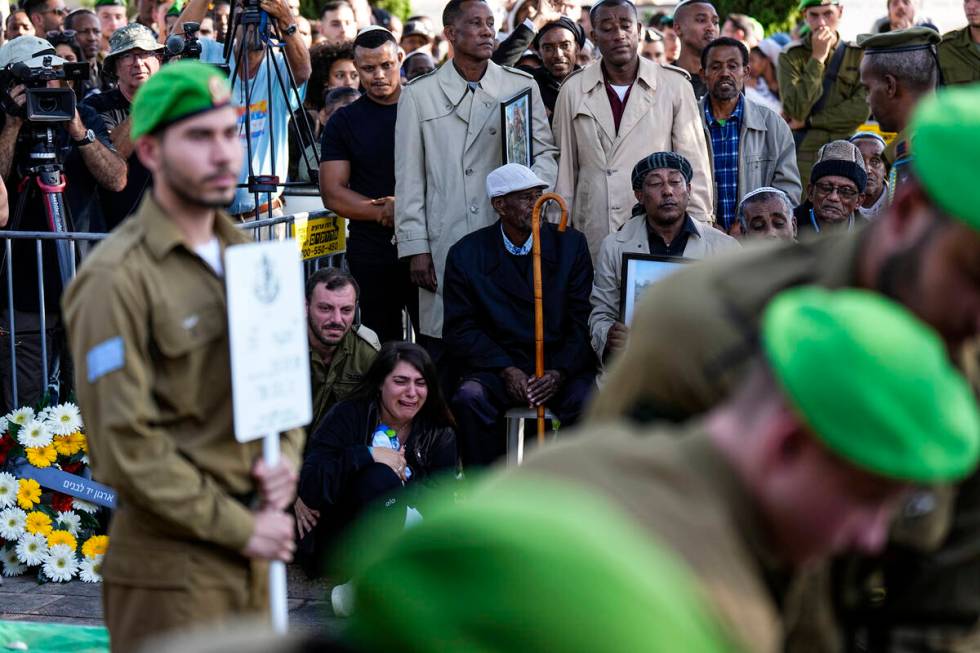 Family and friends of Staff Sergeant Aschalwu Sama mourn during his funeral in Petah Tikva, Isr ...