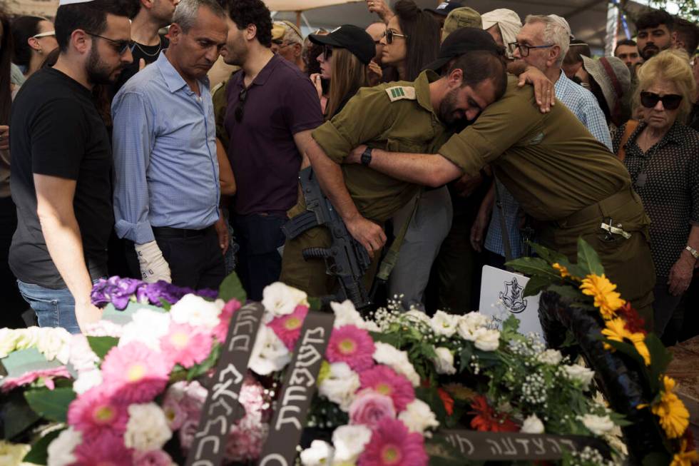 Relatives and friends of Israeli Col. Asaf Hamami mourn during his funeral at the Kiryat Shaul ...