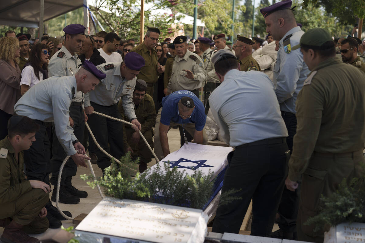 Israeli soldiers carry the coffin of Col. Asaf Hamami during his funeral at the Kiryat Shaul mi ...