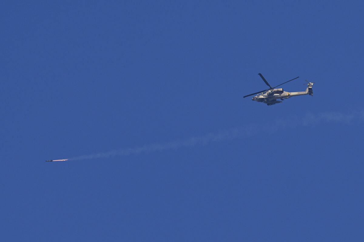 An Israeli Apache helicopter fires a missile in direction of the Gaza Strip, as seen from south ...