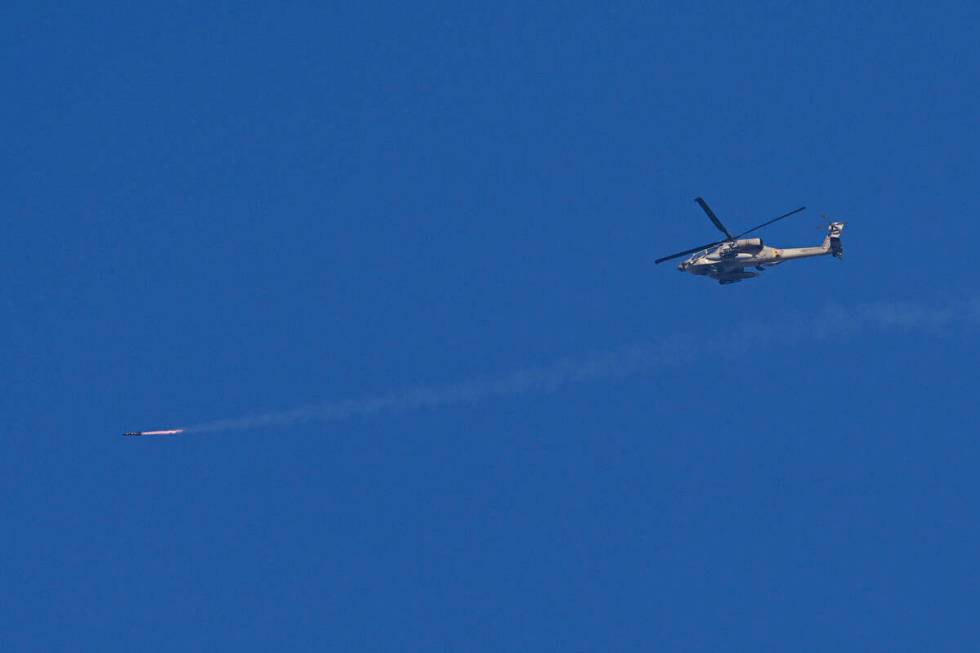 An Israeli Apache helicopter fires a missile in direction of the Gaza Strip, as seen from south ...