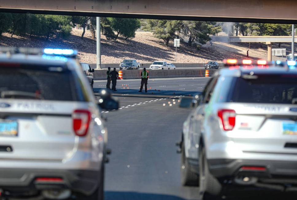 Investigators work the scene of a fatal pedestrian crash on northbound Interstate 15 south of L ...