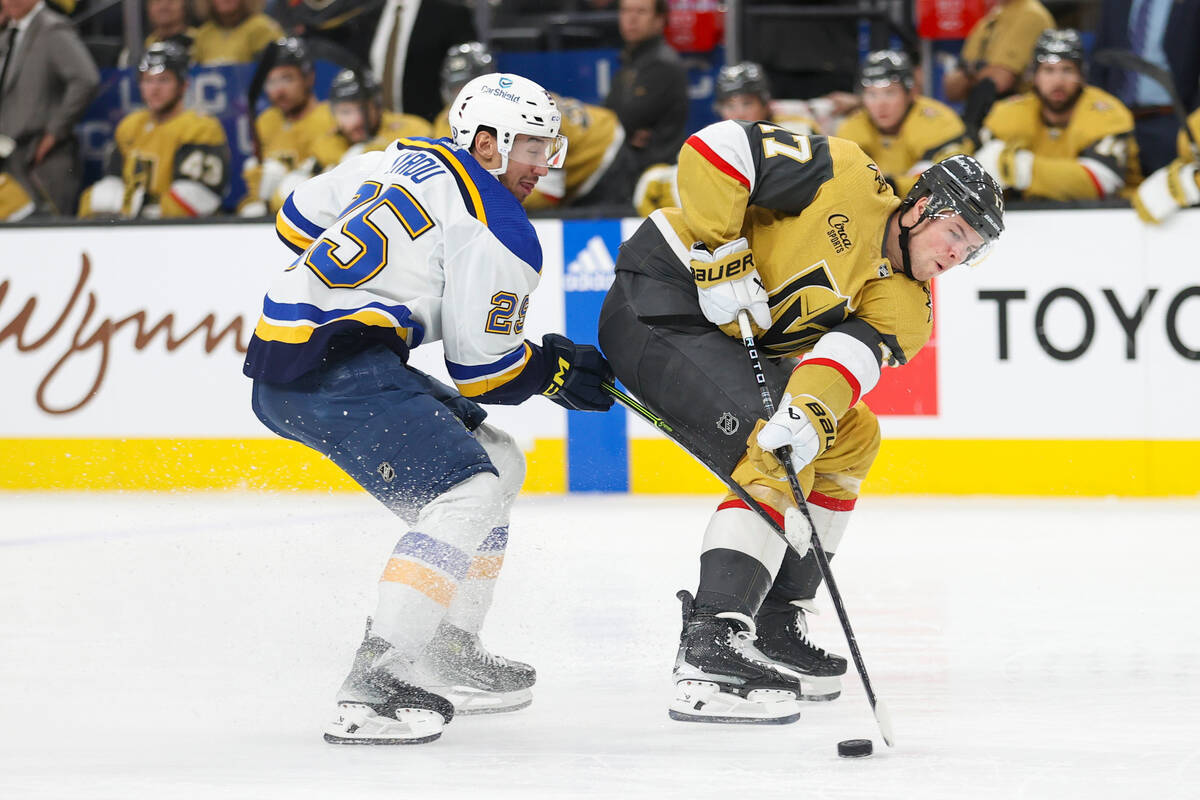 Vegas Golden Knights defenseman Ben Hutton (17) skates past St. Louis Blues center Jordan Kyrou ...